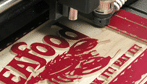 wood seafood sign being engraved